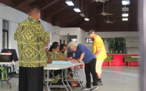 Electors sign the voter roll before casting ballots at the Ili’ili village polling station, today, during the American Samoa General
election. 4 November 2020
