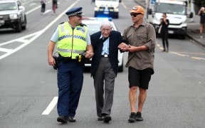 John Sato (C) 95, one of only two Japanese servicemen in the New Zealand army in WWII, took multiple buses from Howick to join the march against racism at Aotea Square.