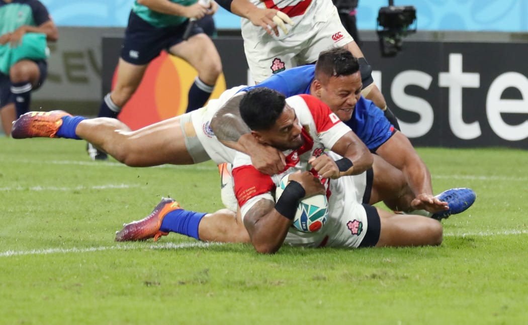 Timothy Lafaele of Japan tries in the first half of the Rugby World Cup Pool A match against Samoa at Toyota Stadium in Toyota City.