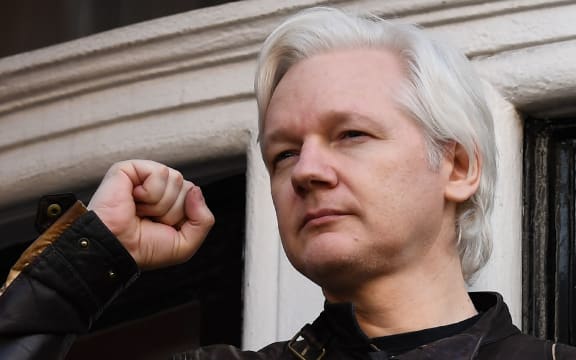 In this file photo taken on May 19, 2017 Wikileaks founder Julian Assange raises his fist prior to addressing the media