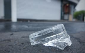 Broken glass outside the Sharland Avenue liquor store.