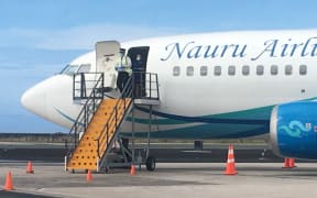 A Nauru Airlines pilot emerges from the aircraft on one of the airline's last flights to Majuro in early 2020. The airline is scheduled to resume air service October 16.