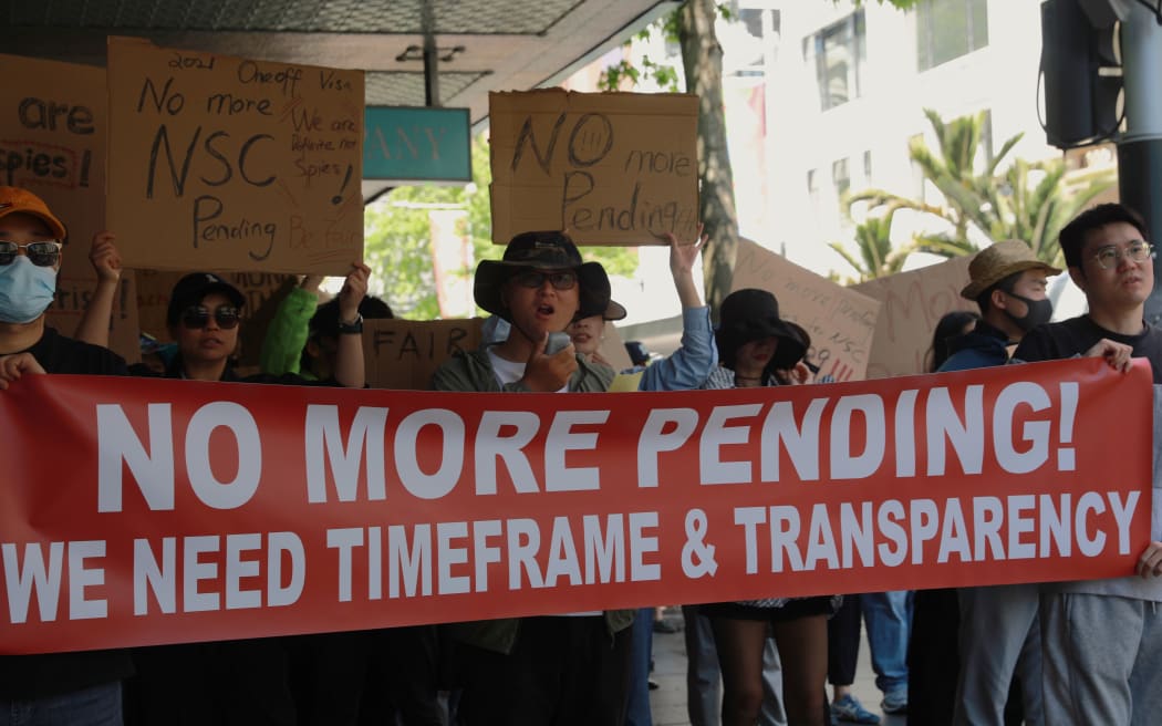 Hundreds of Chinese took to Auckland's Queen St on Sunday (12 November, 2023) to protest against National Security Check delays their Resident Visa applications.