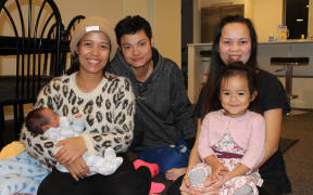 A photo of Vanny Yun with baby Sondra, her husband Sally Yen and Houng Yen holding Vanny and Sally's daughter, Sonila