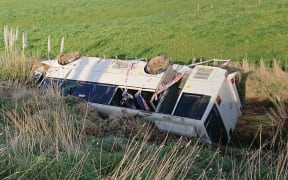 The overturned bus near Sanson.