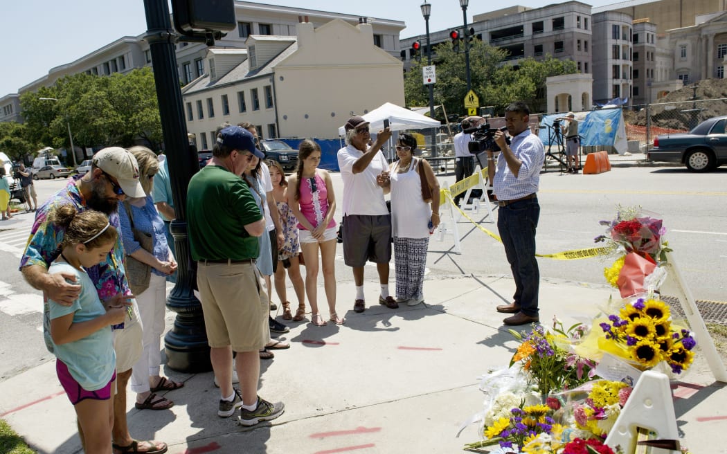 People visit a makeshift memorial near the Emanuel AME Church June 18, 2015 in Charleston.