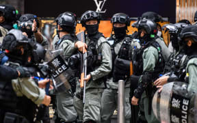 Riot police in the Central district of Hong Kong on 27 May. Police fired pepper-ball rounds and arrested hundreds as they clamped down on protests against a bill banning insults to China's national anthem.