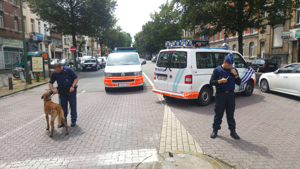 A picture taken on 17 June 2016 showing Belgian police officers standing guard in the district of Etterbeek, in Brussels.