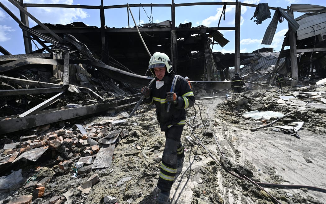 Rescuers clear rubbles of the Amstor mall in Kremenchuk, on 28 June, 2022, one day after it was hit by a Russian missile strike according to Ukrainian authorities.