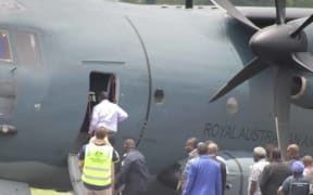 Charlot Salwai boarding an Australian Defence Force plane to survey damage to Vanuatu caused by Cyclone Lola.