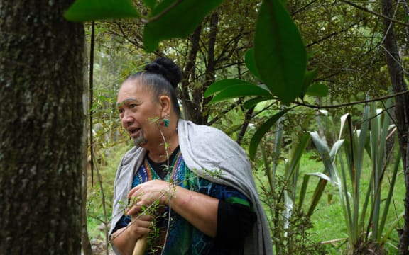Terauoriwa Pere stands outside in the bush