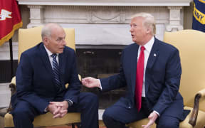 US President Donald Trump (R) speaks with White House Chief of Staff John Kelly