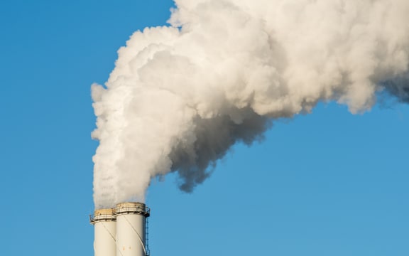 The pipe of a coal power plant with white smoke as a global warming concept.