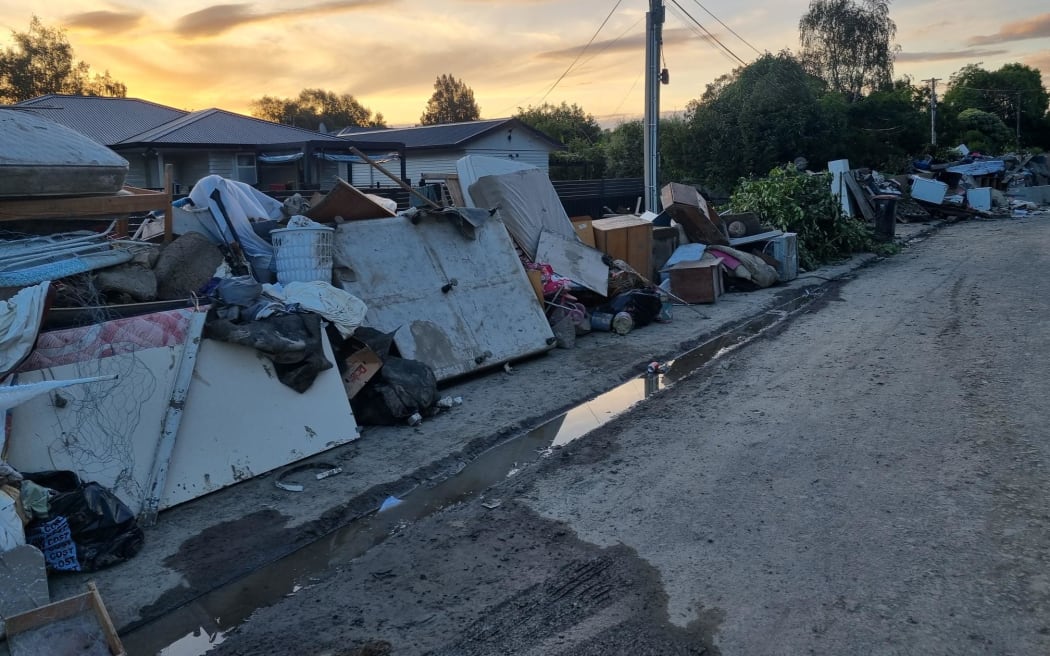 Joll Road, Havelock North 的图片。 该镇基本上没有受到飓风的影响，但有一小部分地区就没那么幸运了。 这条街背靠 Mangarau Stream，被毁坏了。 与邻近街道上修剪整齐的草坪和修剪整齐的树篱形成鲜明对比。