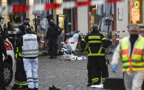 Police and ambulances work at the scene where a car drove into pedestrians in Trier, southwestern Germany.