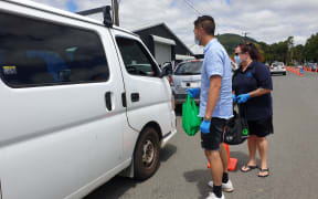 Ngati Wai volunteers handing out supplies to those waiting for Covid testing in Kamo. 26 January 2021.