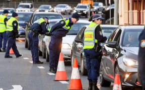 Police in the southern New South Wales (NSW) border city of Albury check cars crossing the state border from Victoria on July 8, 2020.