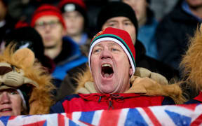A Lions fan rejoices at the match against the Crusaders.