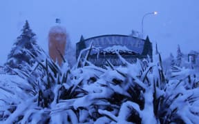 Ohakune's town sign and famous carrot covered in snow after the mid-July storm swept through.