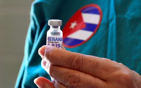 Nurse Xiomara Rodriguez shows a vial of the Cuban Soberana 2 vaccine candidate to be administered to a volunteer during its trial Phase III in Havana, on March 31, 2021.