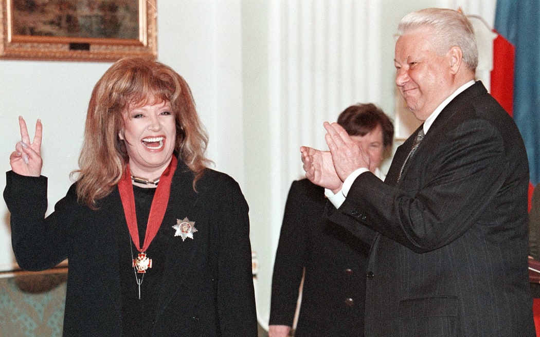 Then-Russian President Boris Yeltsin applauding after awarding Russian pop star Alla Pugacheva the Merit for Fatherland order in the Kremlin in April 1999.