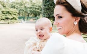 A further picture of the baby prince, alert and with a wide open-mouth smile, was taken by Matt Porteous, chosen by the Duke and Duchess of Cambridge to be their private photographer for the day.