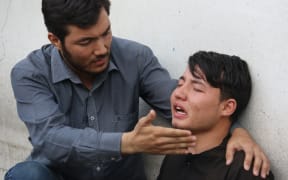 An Afghan resident cries for his relative following a suicide attack in Kabul.
