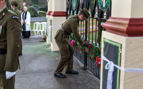 A soldier lays a wreath at Tolaga Bay.