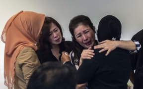 Family members of passengers from missing flight QZ8501 at the airport in Surabaya, East Java.