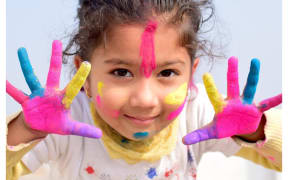 little girl covered in paint