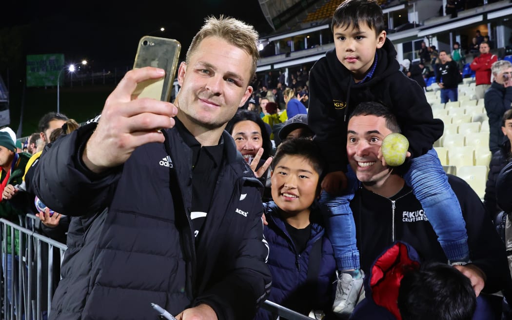 Sam Cane takes selfies with fans.