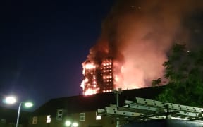 The fire engulfs the Grenfell Tower apartment building.