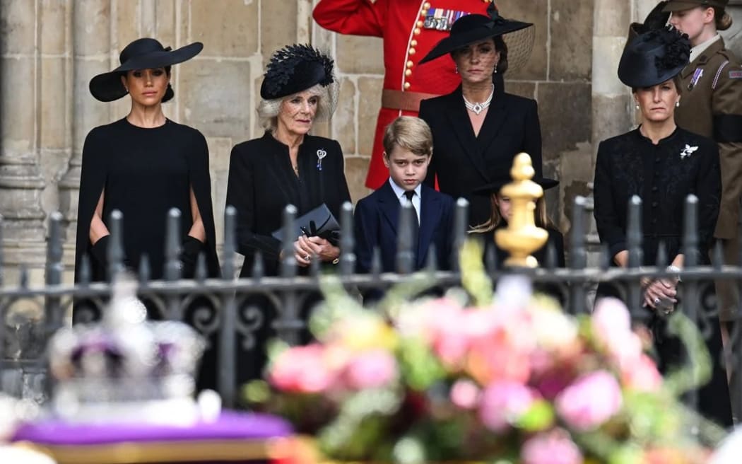 Meghan, Duchess of Sussex, Camilla, Queen Consort, Prince George of Wales, Catherine, Princess of Wales and Sophie, Countess of Wessex look at Queen Elizabeth II's coffin as they leave Westminster Abbey in London.