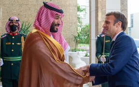 A handout picture provided by the Saudi Royal Palace shows Saudi Crown Prince Mohammed bin Salman (L) receiving French President Emmanuel Macron (R) in Saudi Arabia's Red Sea coastal city of Jeddah on December 4, 2021.