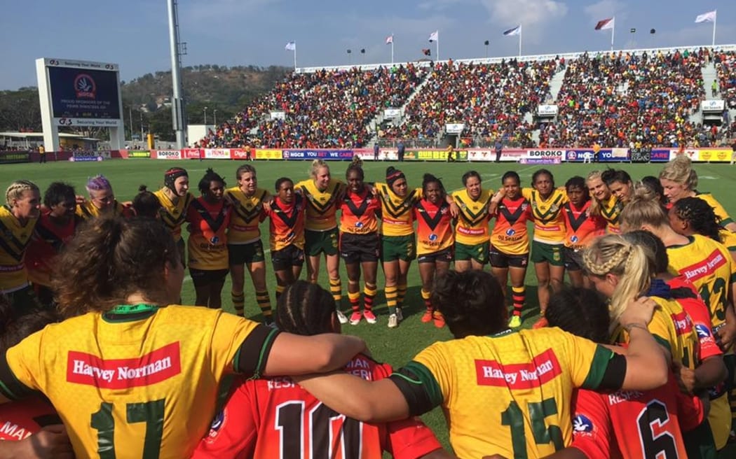 The PNG Orchids and Australian Jilaroos huddle after their test match in Port Moresby.