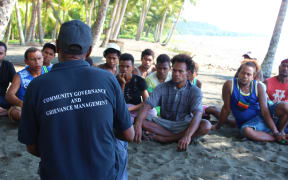 A community officer speaks to young men at Kokana Village on Makira.