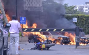 Burning cars at the scene of an explosion at a hotel complex in Nairobi on January 15, 2019.