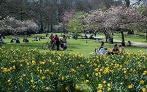 People enjoy exceptionally warm and sunny weather in St James's Park, making the most of eased Coronavirus restrictions, on 30 March, 2021 in London, England.