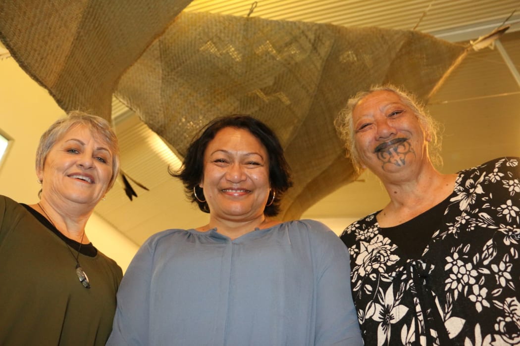 From left to right, Gloria Taituha, Jacqueline McRae-Tarei and Rose Te Ratana at a recent display of their work, standing under waka sails woven by Jacqueline.