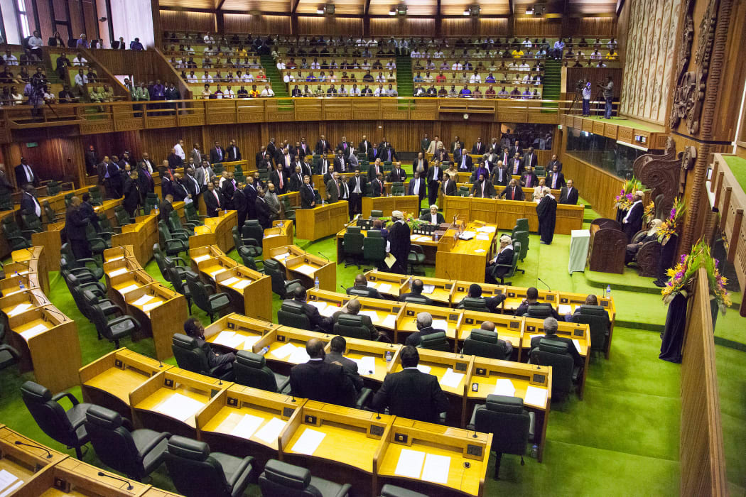 Members of parliament stand to the right of the speaker (R) to approve the vote of Peter O'Neill as prime minister in Port Moresby on August 3, 2012.