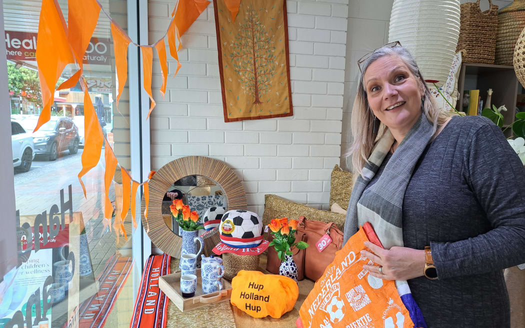 Tauranga Trade Aid retail manager Ingrid Otene propped up an impressive display of Dutch memorabilia in her shop window on 19 July, 2023, for the arrival of the Netherland's women's football team.