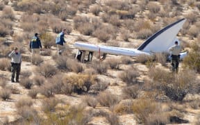 A National Transportation Safety Board team surveys the tail section from the crashed Virgin Galactic SpaceShipTwo.