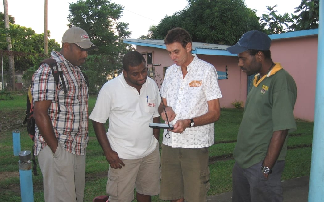 Adrian Sainsbury meeting technicians in Vanuatu, 2007.