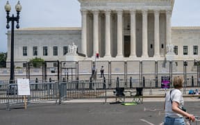 WASHINGTON, DC - JUNE 21: Abortion-rights activist Sadie, 28, stands alone with a sign in front of the U.S. Supreme Court Building on June 21, 2022 in Washington, DC. The Court continues to release opinions as the country awaits a major case decision pertaining to abortion rights.   Brandon Bell/Getty Images/AFP (Photo by Brandon Bell / GETTY IMAGES NORTH AMERICA / Getty Images via AFP)