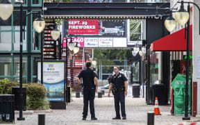 Jacksonville Sheriff's officers patrol around the ships at Jacksonville Landing  after a shooting rampage during a video game tournament at the site claimed four lives.