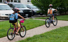 Children cycling on national bike to school day, Arlington, Virginia, US.