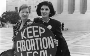 Norma McCorvey (L) with her attorney Gloria Allred outside the Supreme Court in April 1989, where the Court heard arguments in a case that could have overturned the Roe v. Wade decision.