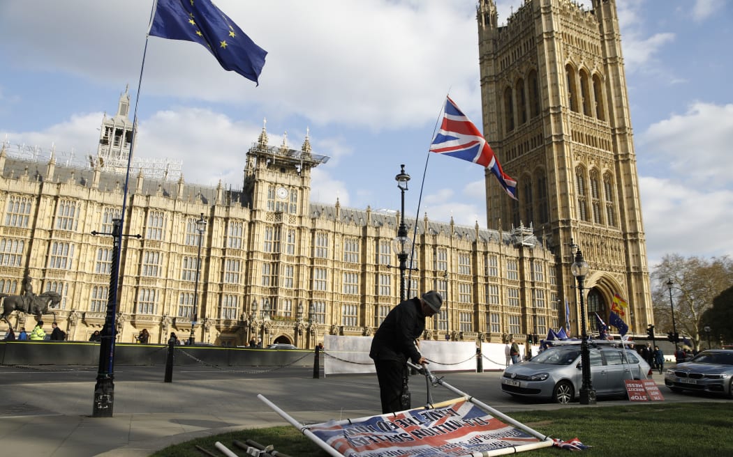 An EU and a Union flag flutter near the Houses of Parliament in central London on March 27, 2019.