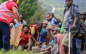 An injured villager is being prepared for evacuation by helicopter from Kombul village to the nearby the city of Lae following a 7.6-magnitude earthquake.