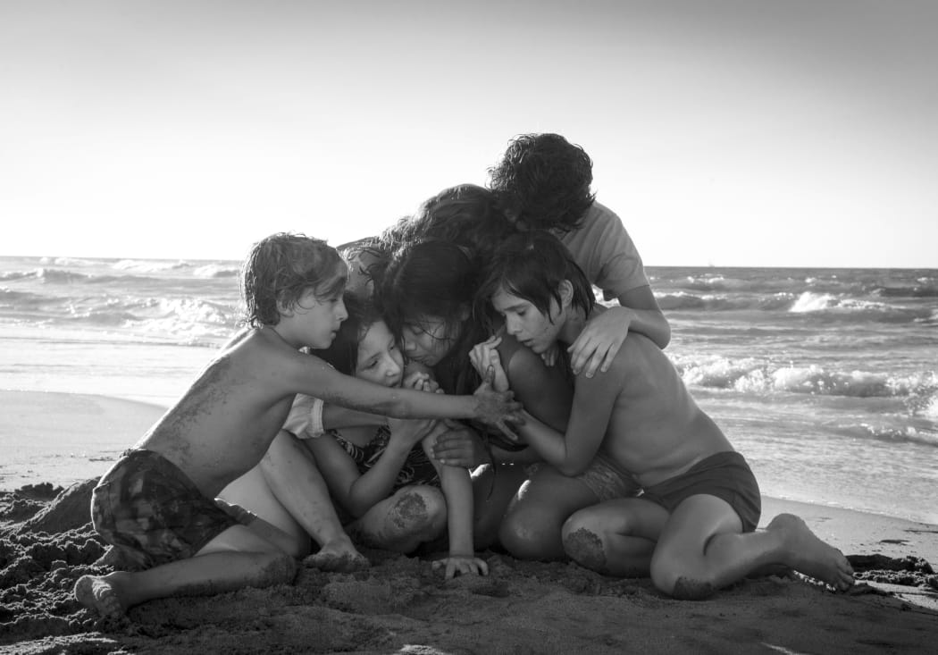 This image released by Netflix shows Yalitza Aparicio, centrer, in a scene from the film "Roma," by filmmaker Alfonso Cuaron.